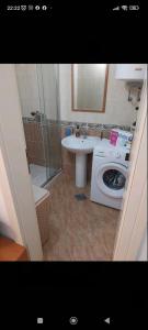a bathroom with a washing machine and a sink at Apartman Elena Budva in Budva