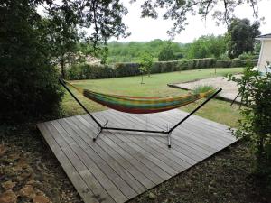 eine Hängematte auf einer Terrasse im Garten in der Unterkunft Gite du chêne vert - Périgord in Salignac Eyvigues + 25 Fotos