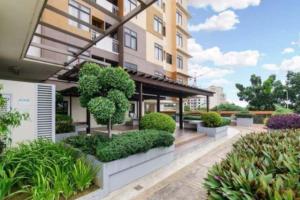 a building with a courtyard with trees and bushes at Mabolo Garden Flats Loft by Cebu Getaway in Sampong