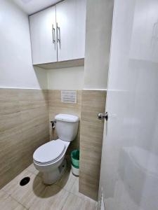 a bathroom with a toilet and a sink at Mabolo Garden Flats Loft by Cebu Getaway in Sampong +14 photos