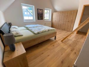 a small bedroom with a bed and a staircase at Ferienwohnung direkt in der Natur in Schmallenberg