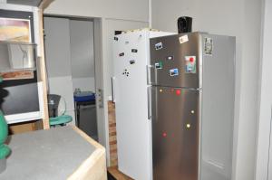 a kitchen with a refrigerator with magnets on it at Gite le Buron in La Bourboule