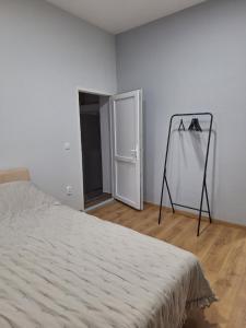 a bedroom with a bed and a mirror in a room at Studio Zmaj in Srbobran