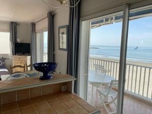 a living room with a view of the ocean at Résidence C2M Appartement sur plage Grau du Roi in Le Grau-du-Roi