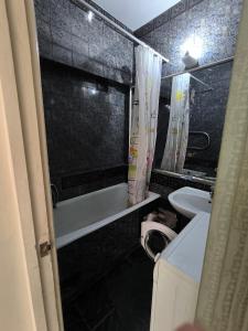 a bathroom with a tub and a toilet and a sink at Brazeri 2-6-9 in Toshkent-Passajir Bekati