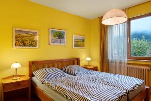 a bedroom with a bed and a window and two lamps at Ferienwohnung Joos in Schiltach