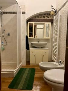 a bathroom with a sink and a shower and two toilets at La Taverna del Ricetto in Candelo +16 photos