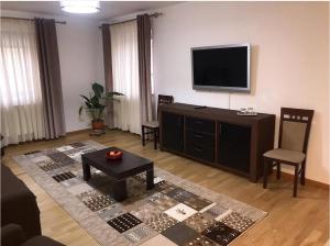 a living room with a flat screen tv on the wall at Casa Pino in Braşov +23 photos