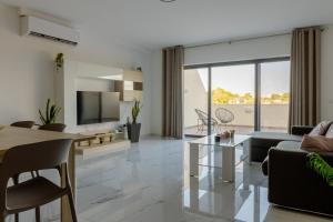 a living room with a couch and a table at Luqa Penthouse 6 with 3 bedroom in Luqa