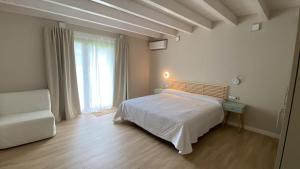 a bedroom with a bed and a couch and a window at House La parada in Nava, Villa de la Sidra in Nava