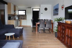 a living room with a couch and a table at Nordseeferienhaus Emma Tossens in Butjadingen