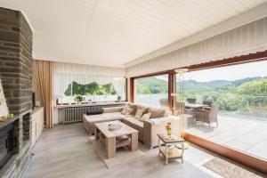 a living room with a couch and a fireplace at Ferienhaus Burgblick in Hürtgenwald