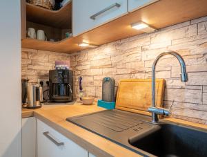 a kitchen sink with a faucet on a counter at Ferienhaus Burgblick in Hürtgenwald