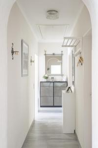 a kitchen with white walls and a white refrigerator at Ferienhaus Burgblick in Hürtgenwald