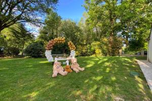 three stuffed animals sitting on the grass in a yard at Clos des chênes in La Houssaye-en-Brie