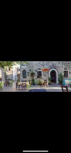 a group of tables and chairs in front of a building at Mimi's House 1 in Chios