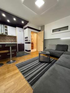 a living room with a couch and a table at Varna Cathedral Apartments in Varna City +33 photos