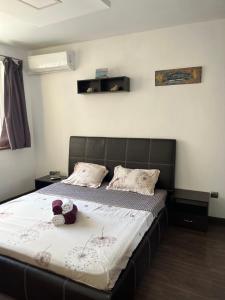 a bedroom with a bed with two teddy bears on it at Varna Cathedral Apartments in Varna City