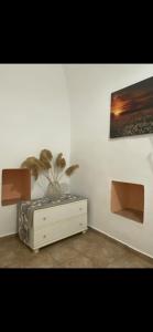 a room with a dresser with a plant on it at Mimi's House 1 in Chios