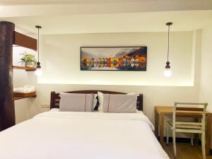 Ein Bett oder Betten in einem Zimmer der Unterkunft Pao Come Boutique House