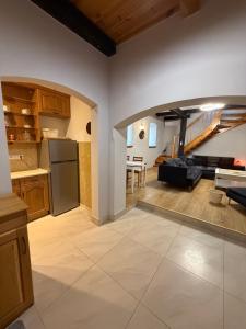 a kitchen and living room with a couch and a table at Kuźnia-Grodno in Krzywa Wieś