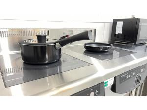 a pot and a pan sitting on a stove at FUMAI SAUNA&INN - Vacation STAY 66364v in Matsue +24 photos