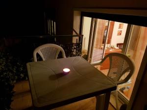 una vela sentada en una mesa en un balcón en Da Cristina Con Amore, en Taormina