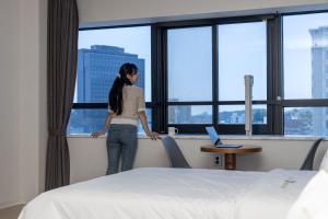 Postel nebo postele na pokoji v ubytování Hotel Wooin
