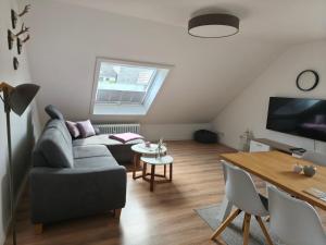 a living room with a couch and a table at Winterberg Centrum mit SSC Sommercard in Winterberg