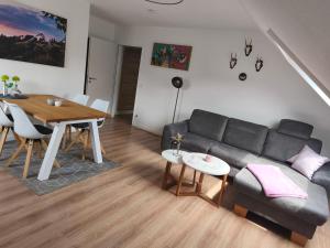 a living room with a couch and a table at Winterberg Centrum mit SSC Sommercard in Winterberg