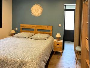 a bedroom with a large bed and a chandelier at Villa patio terrasse privative océan 10 min a pied in Seignosse