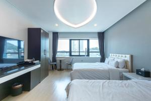Postel nebo postele na pokoji v ubytování Hotel Wooin