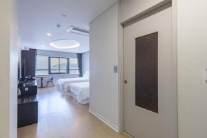 Postel nebo postele na pokoji v ubytování Hotel Wooin