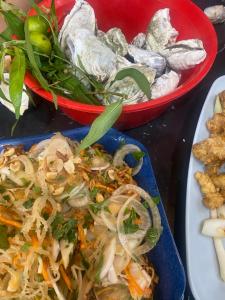 a plate of food with vegetables and other foods at Phúc Long Hiwinwin in Chợ Phước Hải