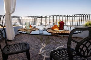 a table with two plates of food on a balcony at A Casa da Nelly Augusta in Augusta