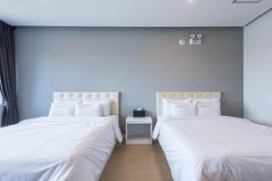 Postel nebo postele na pokoji v ubytování Hotel Wooin