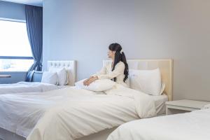 Postel nebo postele na pokoji v ubytování Hotel Wooin