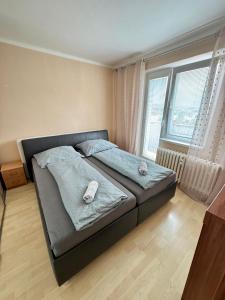 a bedroom with a bed with two pillows on it at Apartmán Športovcov in Dolný Kubín