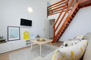 a living room with a couch and a table at Apartments Diana - NEW heated pool in Bol