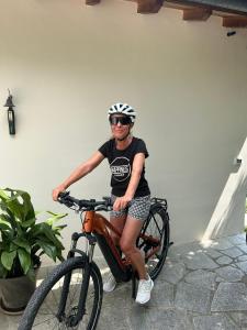 a woman is sitting on a bike at Briciole di Pietra B&B in Dolceacqua +78 photos