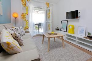 a living room with a couch and a table at Apartments Diana - NEW heated pool in Bol