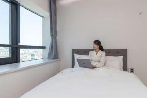Postel nebo postele na pokoji v ubytování Hotel Wooin