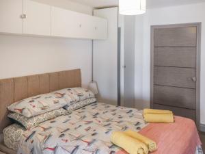 a bedroom with a bed with a comforter on it at Penally Heights Annex in Penally