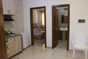 a kitchen with a sink and a toilet in a room at Amaretraouf عماره رؤوف 