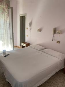 Postel nebo postele na pokoji v ubytování HOTEL Donati