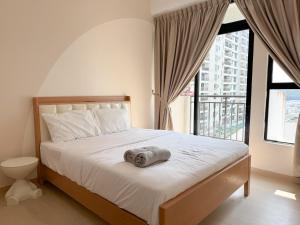 a bedroom with a bed with a towel on it at Skudai Muji Style 2Bedroom 4pax in Skudai +36 photos