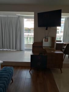 a living room with a couch and a flat screen tv at Sea Studio 22 in Nesebar