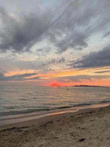a sunset on the beach with the ocean at Hotel Ardian in Golem