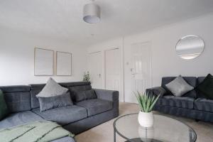 a living room with a couch and a glass table at Harburn House in West Calder +38 photos