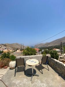 a table and two chairs sitting on a patio at ALEMINAS House 1 in Symi